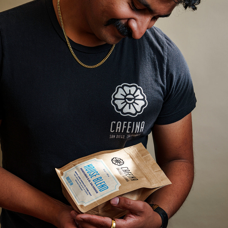 Cafeina Cafe's Owner wearing branded logo shirt